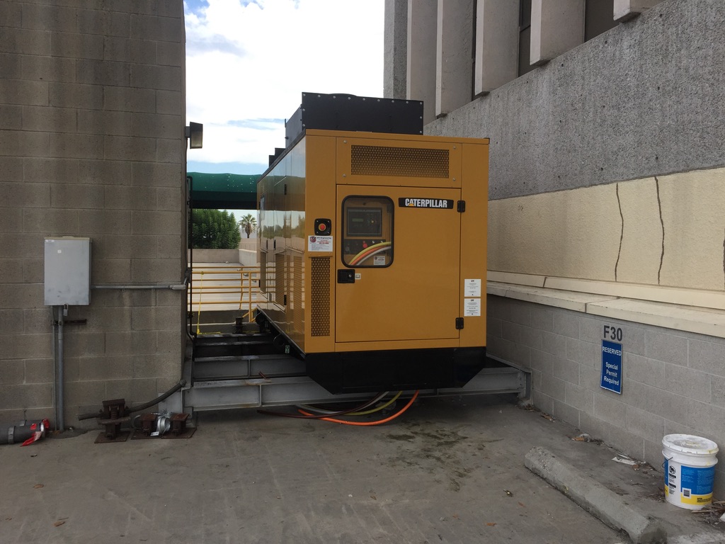 Yellow CAT generator placed on top of white steel beams