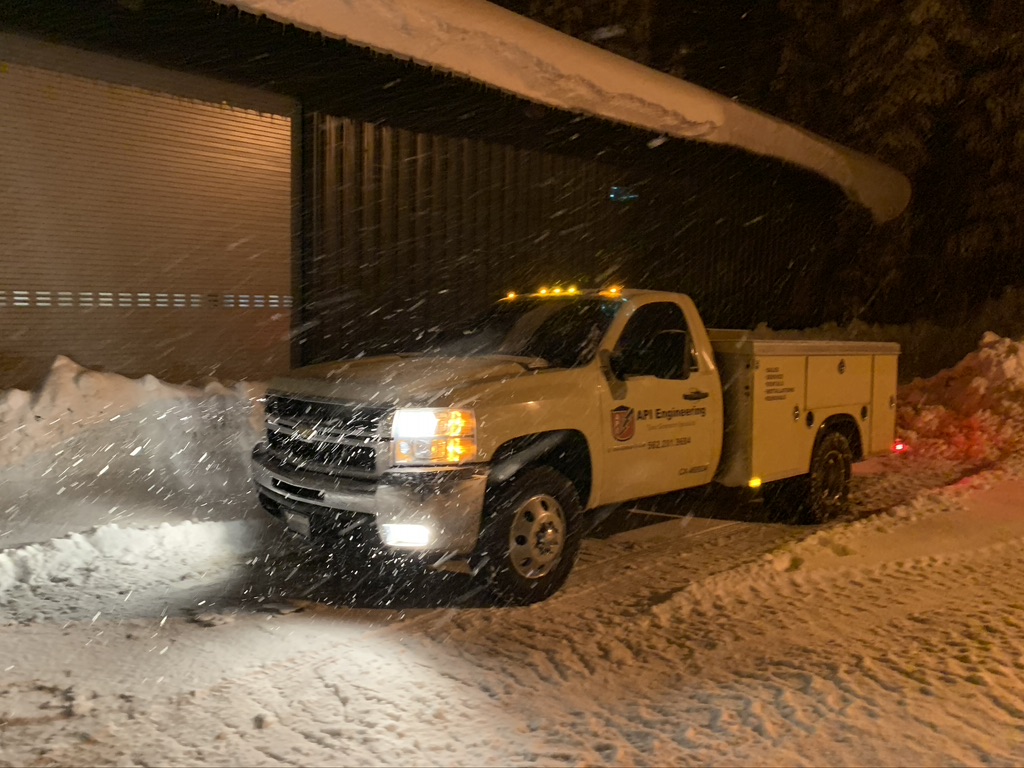 White pickup truck during a heavy snow storm